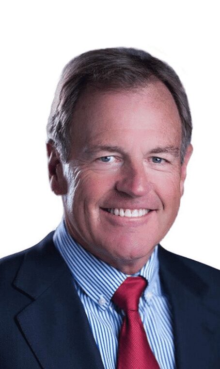 Professional portrait of a middle-aged man in a suit and tie, smiling.