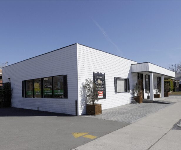 Corner storefront with black window frames and entrance